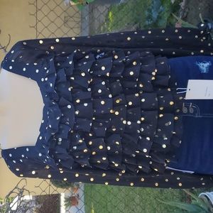 Black top with ruffles in the front. Material is very light not to thick.